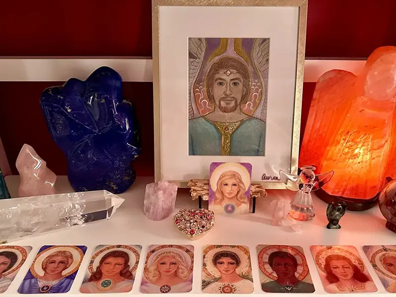 A table with many different colored objects and a picture of jesus.